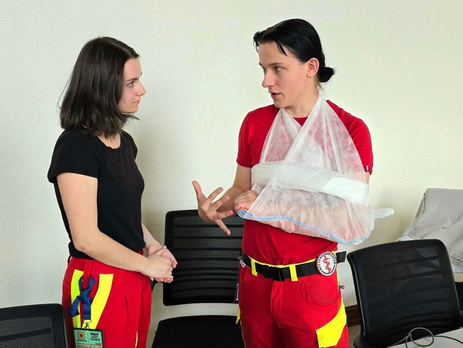Ein Rettungssanitäter des Sanitätskollektiv Leipzig erklärt einer neuen Helferin, wie man einen Knochenbruch richtig immobilisiert.